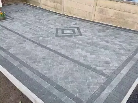 Completed charcoal block paving driveway in Barnsley with contrasting dark border and central diamond feature