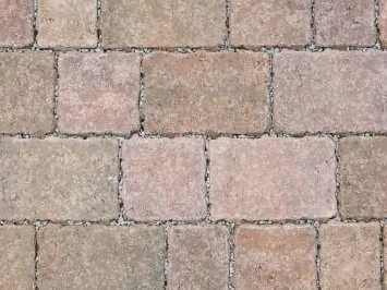 Tumbled block paving with softened edges in warm buff and red tones
