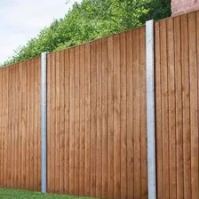 Close-boarded timber fence panels between concrete posts