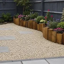 Gravel garden with stepping stones, timber sleeper edging and a planted border