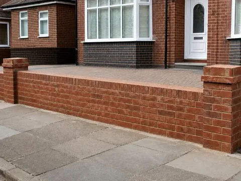 Red brick front boundary wall with piers and a soldier course on top