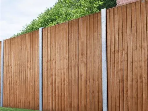 Closeboard timber fence panels between concrete posts